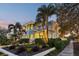Charming two-story home with lush landscaping, palm trees, and a welcoming front entrance at 2001 Beach Se Dr, St Petersburg, FL 33705