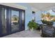 Charming covered front porch with blue accents, decorative tile flooring and comfortable wicker seating at 2001 Beach Se Dr, St Petersburg, FL 33705