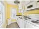 The cozy kitchen features white appliances, ample counter space, and natural light from a window at 2001 Beach Se Dr, St Petersburg, FL 33705