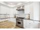 Modern kitchen with stainless steel appliances, granite countertops, and white cabinetry at 2001 Beach Se Dr, St Petersburg, FL 33705