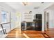 Well-lit kitchen featuring wooden floors, floating shelves, a retro refrigerator, and a wine cooler at 2001 Beach Se Dr, St Petersburg, FL 33705
