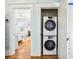 Convenient laundry closet with stacked washer and dryer units in a hallway near a bedroom at 2001 Beach Se Dr, St Petersburg, FL 33705