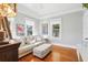 Bright living room featuring hardwood floors, a large sofa, and natural light from multiple windows at 2001 Beach Se Dr, St Petersburg, FL 33705