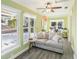 Bright living room features hardwood floors, a ceiling fan, and many windows with a comfortable sitting area at 2001 Beach Se Dr, St Petersburg, FL 33705