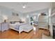 Light-filled main bedroom with hardwood floors and a comfortable seating area bathed in natural light at 2001 Beach Se Dr, St Petersburg, FL 33705