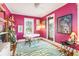 Vibrant office space featuring bright magenta walls, hardwood floors, and ample natural light at 2001 Beach Se Dr, St Petersburg, FL 33705