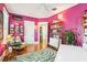 Bright office space featuring bright magenta walls, hardwood floors, and custom bookshelves at 2001 Beach Se Dr, St Petersburg, FL 33705
