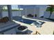 Relaxing backyard pool with an integrated hot tub, a fire pit, and comfortable patio furniture at 2001 Beach Se Dr, St Petersburg, FL 33705