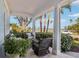 Inviting covered porch with comfortable wicker seating and scenic neighborhood views at 2001 Beach Se Dr, St Petersburg, FL 33705