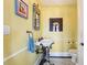 Unique powder room with yellow walls, a pedestal sink, and a decorative mirror at 2001 Beach Se Dr, St Petersburg, FL 33705