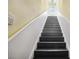 Hallway staircase with freshly painted white wainscotting and black stairs leading to the second floor at 2001 Beach Se Dr, St Petersburg, FL 33705