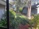 Landscaped backyard with mature trees and shrubs at 5357 Cobblestone Ct, Wesley Chapel, FL 33543