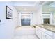 Bathroom with a bathtub, double vanity, and granite countertop at 5357 Cobblestone Ct, Wesley Chapel, FL 33543