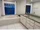 Bathroom with jetted tub and granite vanity at 5357 Cobblestone Ct, Wesley Chapel, FL 33543