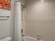 Clean bathroom with shower/tub combo and white tile at 5357 Cobblestone Ct, Wesley Chapel, FL 33543