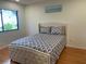 Bedroom with light gray bedding and wood floors at 5357 Cobblestone Ct, Wesley Chapel, FL 33543