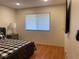Bright bedroom with wood flooring, a gray bed, and window blinds at 5357 Cobblestone Ct, Wesley Chapel, FL 33543