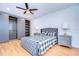 Bedroom with gray upholstered bed, wood floors, and large closet at 5357 Cobblestone Ct, Wesley Chapel, FL 33543