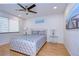 Light and airy bedroom with a queen-size bed and hardwood floors at 5357 Cobblestone Ct, Wesley Chapel, FL 33543