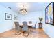 Elegant dining room with white table, gray chairs, and a chandelier at 5357 Cobblestone Ct, Wesley Chapel, FL 33543