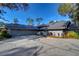 Gray house with a dark gray roof and landscaping at 5357 Cobblestone Ct, Wesley Chapel, FL 33543