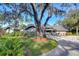 Gray house with a dark gray roof and landscaping at 5357 Cobblestone Ct, Wesley Chapel, FL 33543