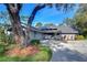 Gray house with a dark gray roof and landscaping at 5357 Cobblestone Ct, Wesley Chapel, FL 33543