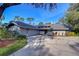 Gray house with a dark gray roof and landscaping at 5357 Cobblestone Ct, Wesley Chapel, FL 33543