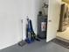 Garage interior with water heater and vacuum cleaner at 5357 Cobblestone Ct, Wesley Chapel, FL 33543