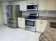 Kitchen with stainless steel appliances and granite countertops at 5357 Cobblestone Ct, Wesley Chapel, FL 33543