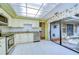 Kitchen with granite countertops, stainless steel appliances, and access to patio at 5357 Cobblestone Ct, Wesley Chapel, FL 33543