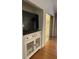 Living area with media console and mirrored closet at 5357 Cobblestone Ct, Wesley Chapel, FL 33543