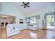 Living room with vaulted ceiling, hardwood floors, and sectional sofa at 5357 Cobblestone Ct, Wesley Chapel, FL 33543