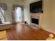 Bright living room featuring hardwood floors and a fireplace at 5357 Cobblestone Ct, Wesley Chapel, FL 33543
