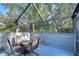 Screened patio with seating and a fire pit, ideal for outdoor gatherings at 5357 Cobblestone Ct, Wesley Chapel, FL 33543