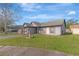 Beautiful home featuring an open lawn, fountain, shutters, and an attached garage at 7908 E White Water Ct, Tampa, FL 33637