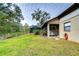 Large grassy backyard with a screened patio and gazebo at 807 Belle Timbre Ave, Brandon, FL 33511