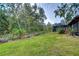 Expansive backyard with lush landscaping and a screened enclosure at 807 Belle Timbre Ave, Brandon, FL 33511