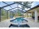 Relaxing freeform pool with a covered patio and surrounding landscaping at 807 Belle Timbre Ave, Brandon, FL 33511