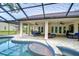 Inviting pool area with covered patio, lush landscaping, and ample seating at 807 Belle Timbre Ave, Brandon, FL 33511