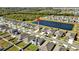 Community overview with lake and solar panels on homes at 16743 Carlton Pond St, Wimauma, FL 33598