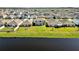 Houses with solar panels and a lake in the background at 16743 Carlton Pond St, Wimauma, FL 33598