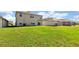 Large backyard with green grass and houses in background at 16743 Carlton Pond St, Wimauma, FL 33598