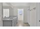 Bathroom with double vanity, marble countertop, and shower at 16743 Carlton Pond St, Wimauma, FL 33598