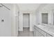 Bathroom with double vanity, marble countertop, and walk-in closet at 16743 Carlton Pond St, Wimauma, FL 33598
