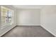 Simple carpeted bedroom with large window and blinds at 16743 Carlton Pond St, Wimauma, FL 33598