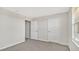 Bedroom with neutral walls, carpet, and two doors at 16743 Carlton Pond St, Wimauma, FL 33598