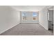 Bright bedroom with neutral carpeting and two large windows at 16743 Carlton Pond St, Wimauma, FL 33598