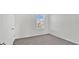 Simple bedroom with neutral walls and carpet, and a window at 16743 Carlton Pond St, Wimauma, FL 33598