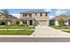 Two-story house with a two-car garage and a landscaped front yard at 16743 Carlton Pond St, Wimauma, FL 33598